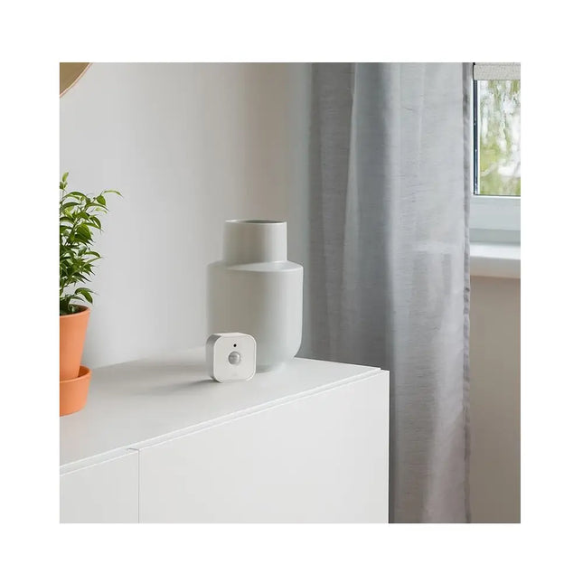 A freestanding Eve Motion (Matter) wireless smart home sensor with 120-degree field of view and IPX3 water resistance for indoor and outdoor motion tracking.