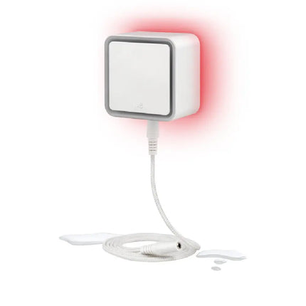 Eve Water Guard connected smart leak detector plugged into a wall outlet with its 2-meter sensing cable attached.