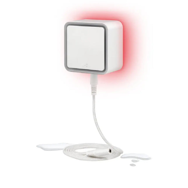 Eve Water Guard connected smart leak detector plugged into a wall outlet with its 2-meter sensing cable attached.