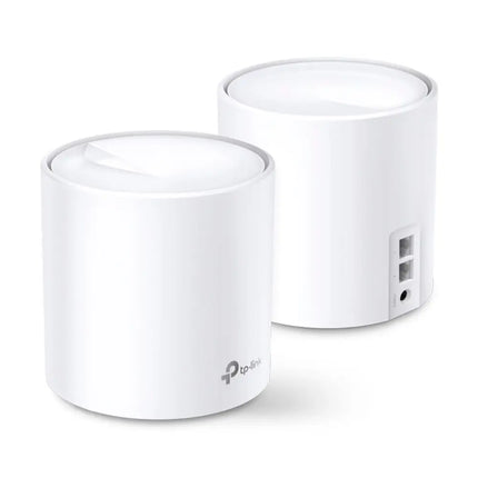 A white TP-Link Deco X20 mesh Wi-Fi 6 unit blending seamlessly into modern home decor on a wooden living room shelf.