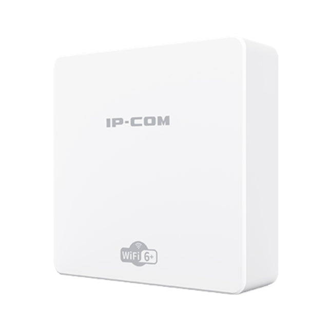 An IP-COM Pro-6-IW AX3000 in-wall access point installed flush into a wall plate inside a modern hotel room or office.