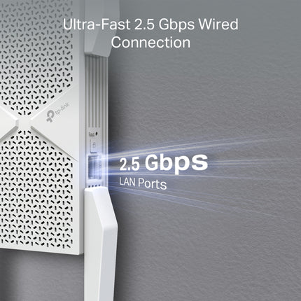 The TP-Link RE655BE Wi-Fi 7 range extender installed in a modern home office, supplying low-latency internet to a nearby desktop computer.