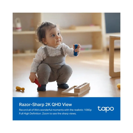 A Tapo C222 smart AI camera sitting on a shelf in a baby nursery, utilizing its 2K QHD resolution and crying detection features.