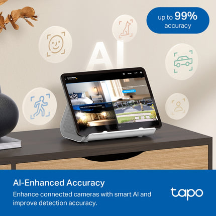The compact TP-Link Tapo H500 CentralHub resting discreetly on a modern smart home media desk next to household tech accessories.