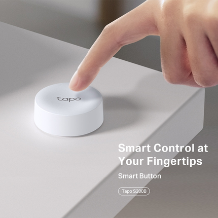 A hand pressing the Tapo S200B smart button, demonstrating the single tap, double tap, and rotating dial actions for custom smart home control.