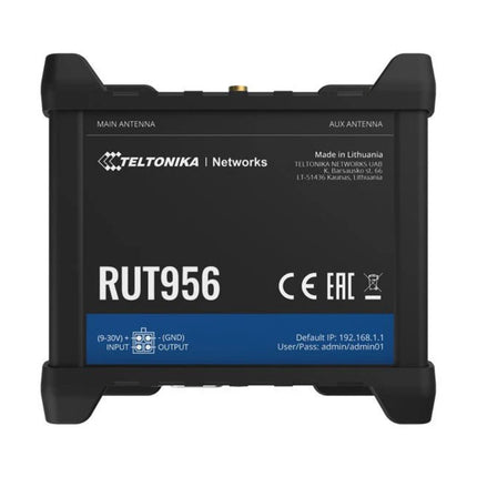 Isometric top view of the rugged Teltonika RUT956 industrial 4G LTE router shown with connected external mobile, Wi-Fi, and GNSS magnetic antennas.