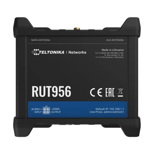 Isometric top view of the rugged Teltonika RUT956 industrial 4G LTE router shown with connected external mobile, Wi-Fi, and GNSS magnetic antennas.