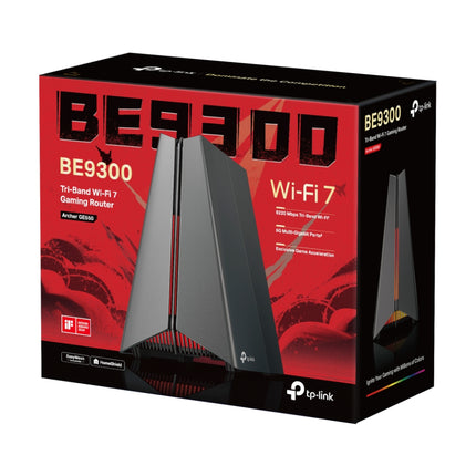 The sleek, pyramid-style TP-Link Archer GE550 gaming router glowing with multi-colour RGB lighting on a gaming desk setup.