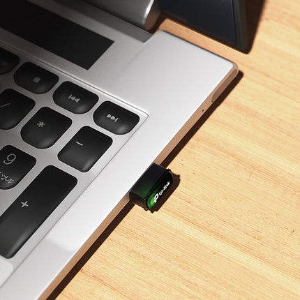 Ultra-small Archer T1300U Nano AC1300 Wi-Fi adapter plugged into the USB port of a sleek laptop.