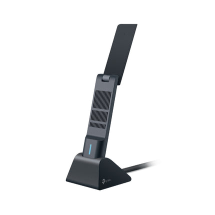 The Archer TXE70UH Wi-Fi 6E adapter positioned on a desk in its included high-speed USB 3.0 cradle.