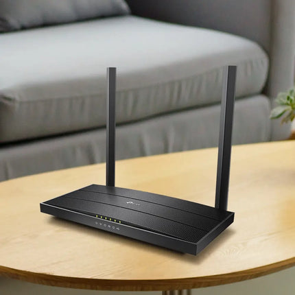 A smartphone displaying the TP-Link Tether app user interface next to the Archer VR400 modem router, demonstrating easy home network setup.