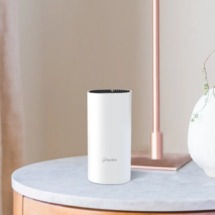 A three-pack of TP-Link Deco M4 units working together to provide seamless AC1200 mesh Wi-Fi coverage for large homes, eliminating dead zones up to 5,500 square feet.