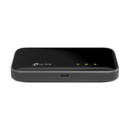 Compact, pocket-sized TP-Link M7400 4G LTE-Advanced MiFi router on a desk, perfect for travel and remote work.