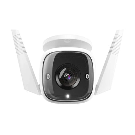 TP-Link Tapo TC65 outdoor security camera mounted on an exterior wall, demonstrating its IP66 weatherproof durability during rain.