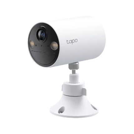 The TP-Link TC82 wire-free camera operating at night with its two bright integrated spotlights activated to capture full-color 2K security footage.