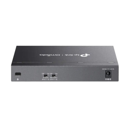 Close-up view of the physical hardware DIP switches on the TP-Link TL-SG1006PP switch, showcasing toggles for Extend Mode transmission up to 250m and PoE Auto Recovery.