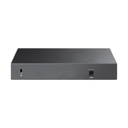 The compact TP-Link TL-SG108-M2 fanless switch running quietly on a desktop desk setup for high-speed home networking.