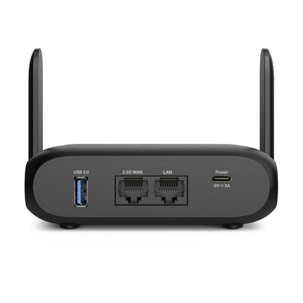Unboxed contents of the TP-Link Roam 7 kit including the travel router, USB-C power supply, flat Ethernet cable, and global plug adapters.
