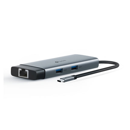 The compact TP-Link UH6120C 6-in-1 docking station connected to a thin laptop on an office desk, expanding ports for mobile workstations.