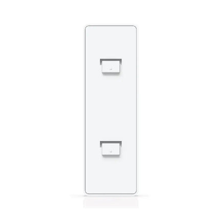 Ubiquiti UACC-Switch-FM deployed on a clean office wall supporting a compact UniFi switch.