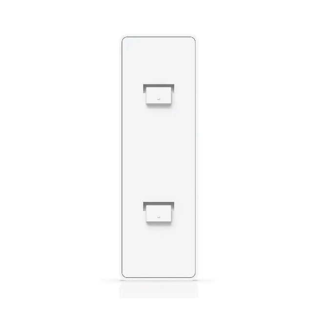 Ubiquiti UACC-Switch-FM deployed on a clean office wall supporting a compact UniFi switch.