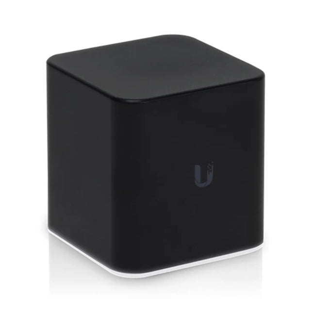 Close-up of the bottom edge of the Ubiquiti airCube AC displaying its ambient white LED status ring illuminated on a tabletop.