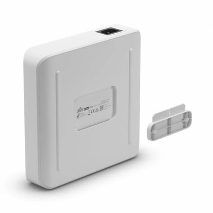 The included interlocking wall mount bracket accessory aligned with the backplate mounting slots of the UniFi Switch Lite 16 PoE for vertical surface installation.