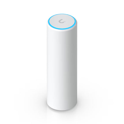 Compact cylindrical white Ubiquiti UniFi U6 Mesh WiFi 6 access point standing upright on a desk with glowing blue LED status ring at the base.