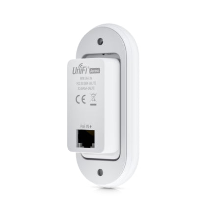 Side profile view of the compact UniFi UA-Lite access reader mounted flush against a modern office wall frame, highlighting its slim architectural footprint.